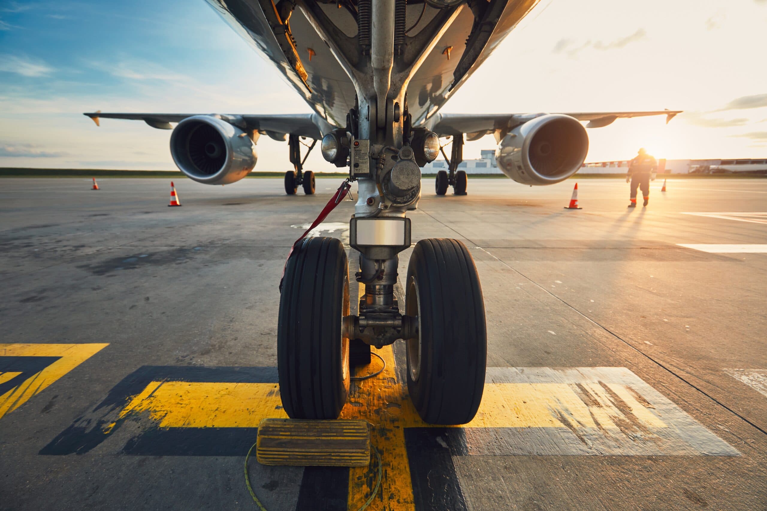 Aircraft on the ground during golden hour at the airport.